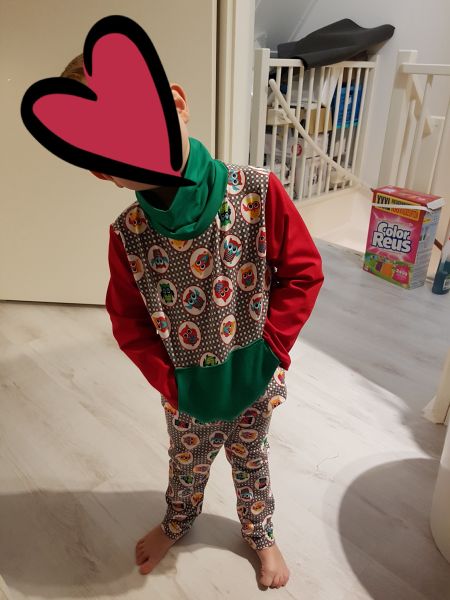 Boy with matching set of pants and shirt. Fabric with owls and red sleeves and green neck
