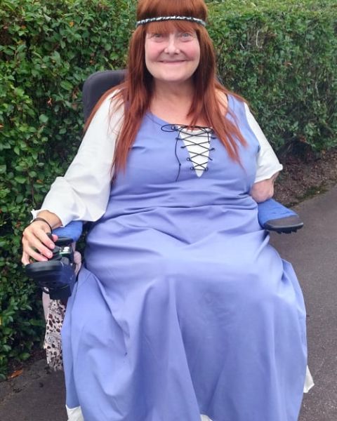 Woman in wheelchair with a Viking inspired dress in lavender and white