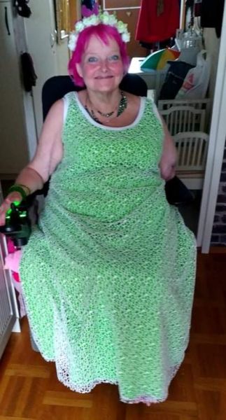 Woman in wheelchair with a green dress on