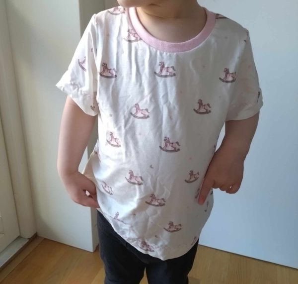 Girl with shirt Marcus on, with rocking horses