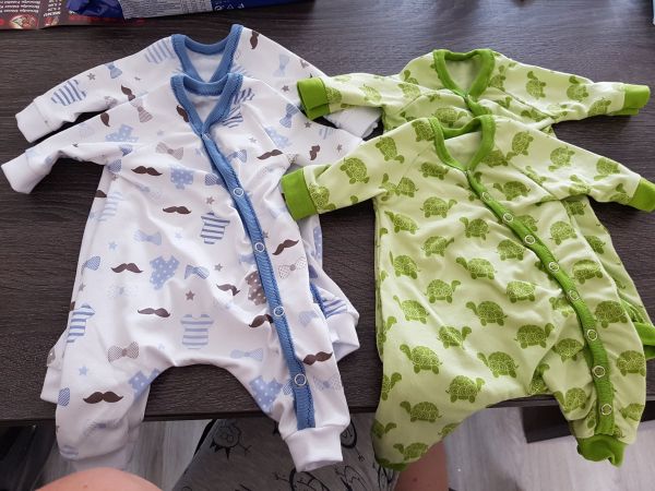 2 sets of preemie clothes. One white with moustaches and one green with turtles