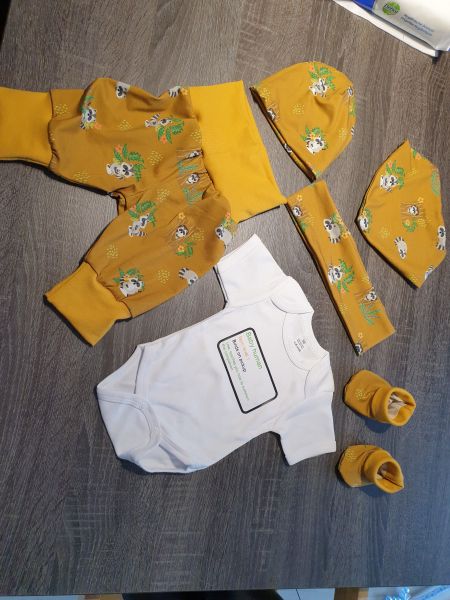 A set of pants, hat, bib, booties and romper. The romper has text for a gamer baby