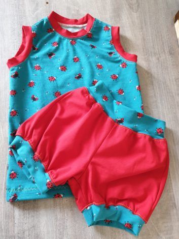 Sleeveless shirt with ladybugs and red shorts, matching