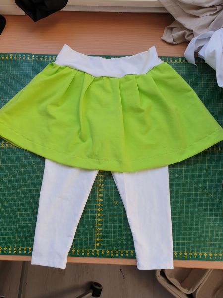 White tights with a green skirt attached